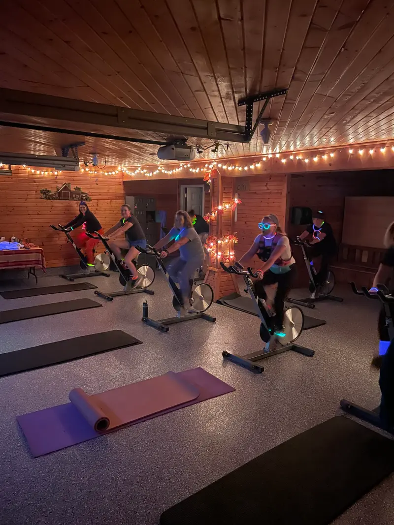 Participants riding stationary bikes during a spin class at Barn Fitness.