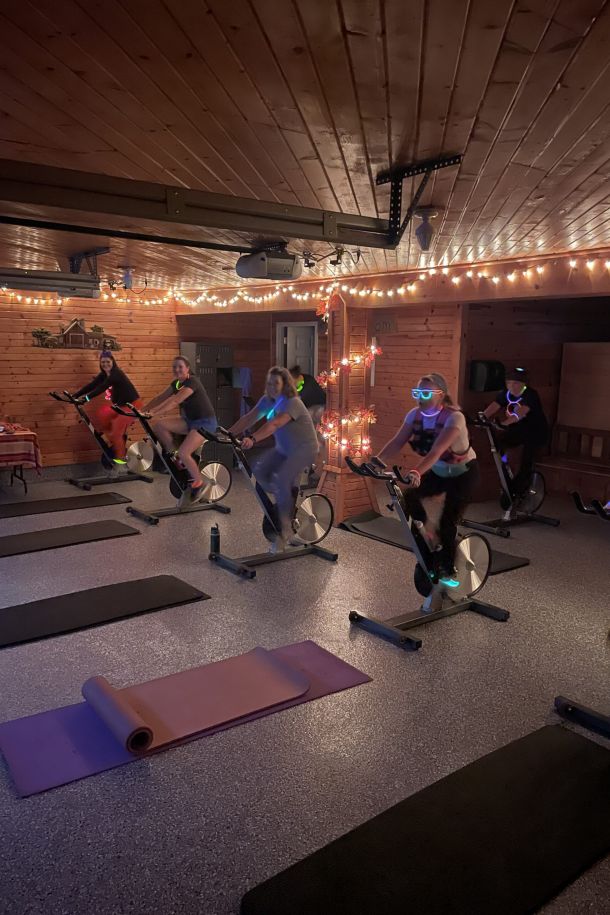 Participants riding stationary bikes during a spin class at Barn Fitness.